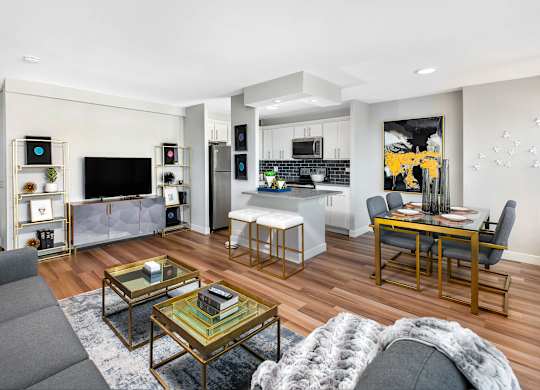 A modern living room with a grey sofa and a glass coffee table.