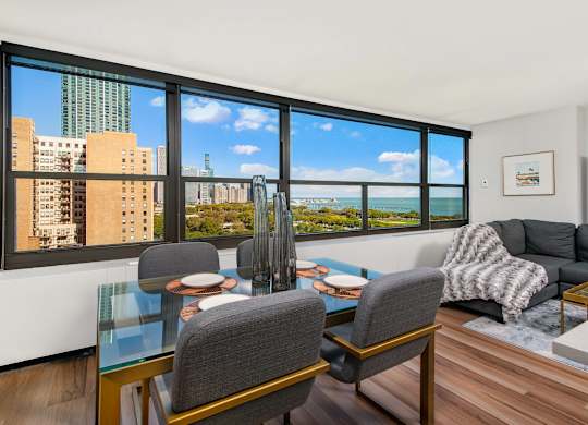 A living room with a view of the cityscape through the windows.