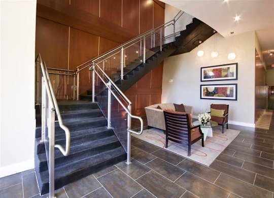 A staircase with a metal railing and wooden steps.