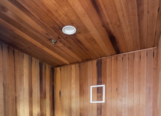 an empty sauna with wooden walls and floors