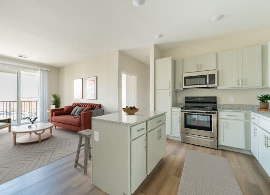 an open kitchen and living room with a couch and a table
