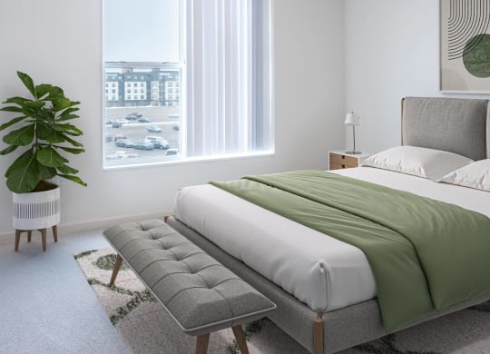 a bedroom with a bed and a chair and a window