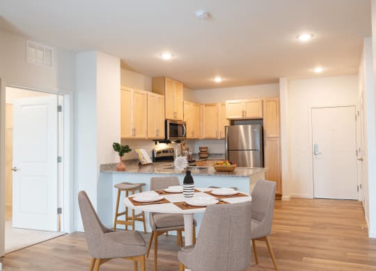 an open kitchen and dining room with a table and chairs