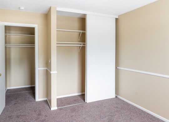 a bedroom with a wardrobe and a carpeted floor