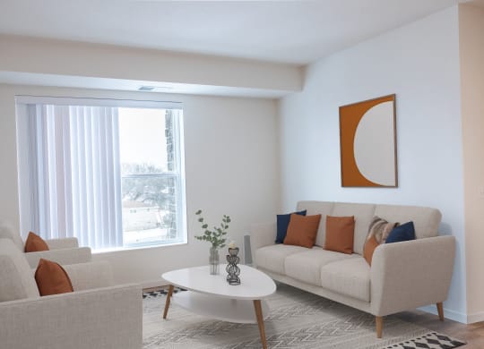 a living room with a couch and a table and a window