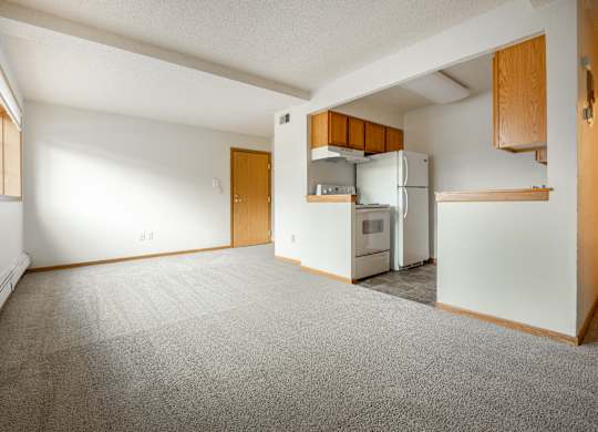 an empty living room with a kitchen in the corner at Ames Lake Neighborhood Apartments, St. Paul, MN, 55106