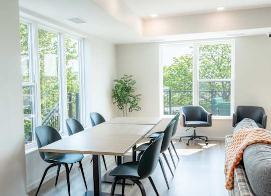 A conference room with a long table and chairs.