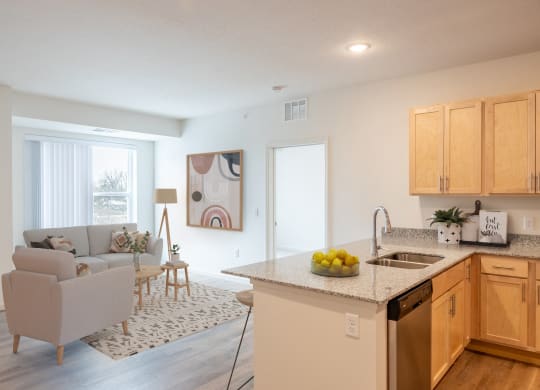 an open kitchen and living room with a couch and a table