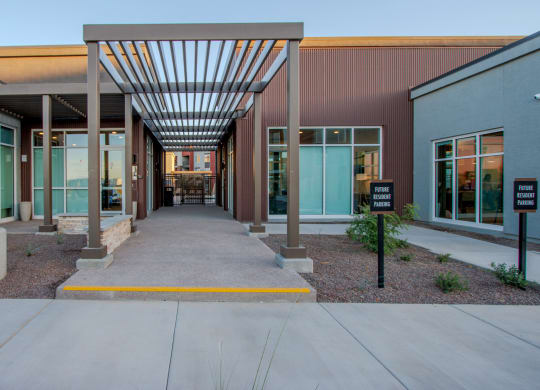 the entrance to a building with a covered walkway and columns