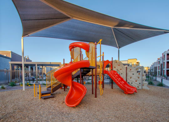 a playground with a slide and a tube