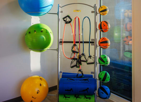 a group of balloons and equipment in a room with a window