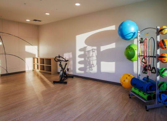 a workout room with exercise equipment and a shadow on the wall