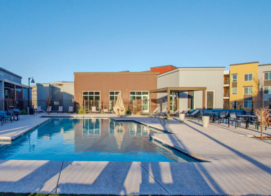 a swimming pool with a building in the background