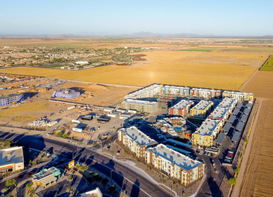 an aerial view of a city with buildings and a field