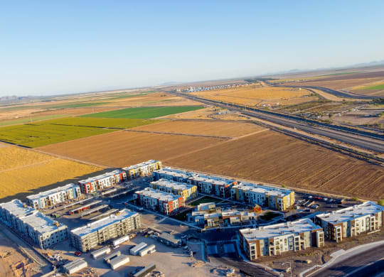 an aerial view of an industrial area with fields and buildings