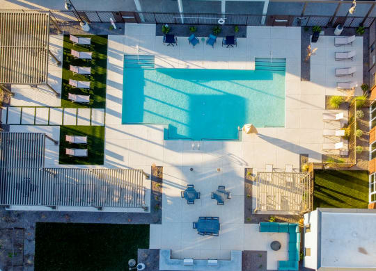 an aerial view of a pool in the middle of a building