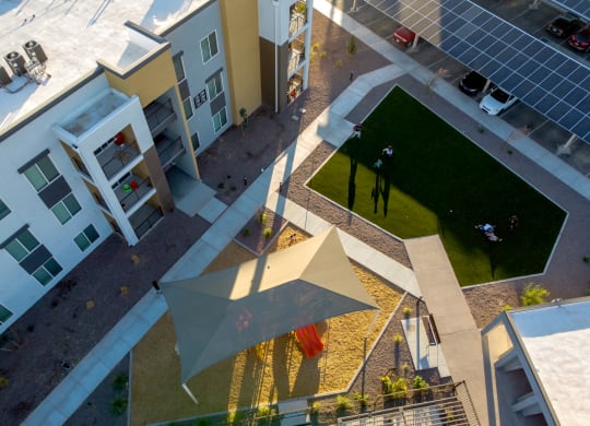 an aerial view of an apartment complex with an umbrella in the middle
