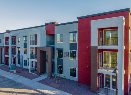 a row of colorful apartment buildings in front of a blue sky