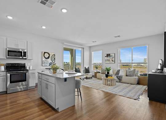A modern kitchen with a large island and stainless steel appliances at Copa Flats Apartments, Maricopa