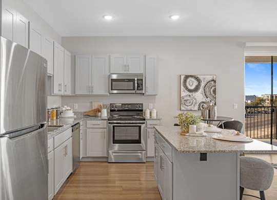 A modern kitchen with stainless steel appliances and white cabinets at Copa Flats Apartments, Maricopa, AZ, 85138
