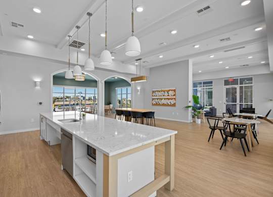 A modern kitchen with a large island and pendant lights at Copa Flats Apartments, Apartments, Maricopa, AZ
