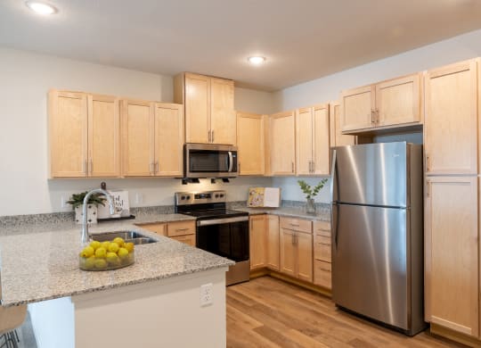 a kitchen with stainless steel appliances and granite counter tops