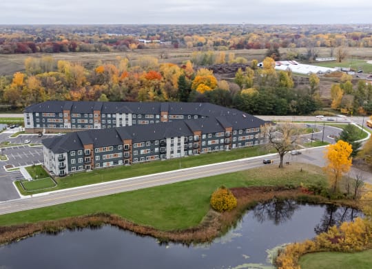 an aerial view of a Londin Crossing next to a pond