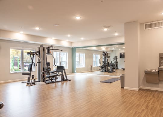 a gym with exercise equipment and a window
