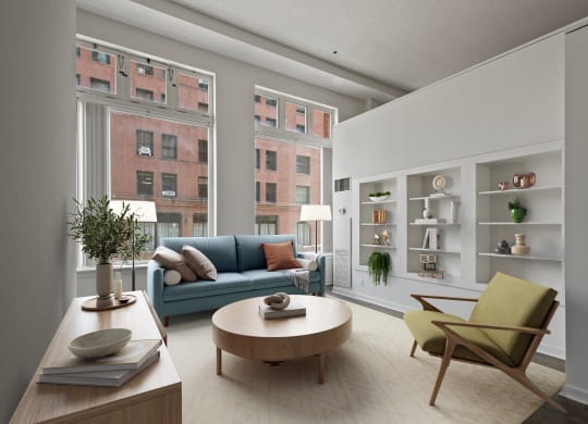 a living room with a blue couch and a round coffee table