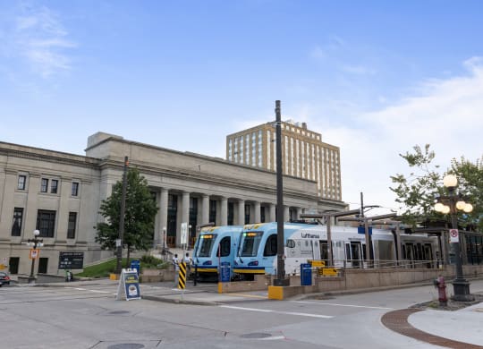 a train on the tracks in front of a building