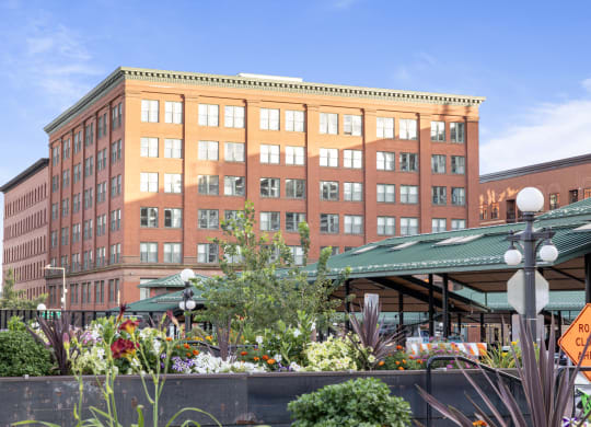 a large brick building with a garden in front of it