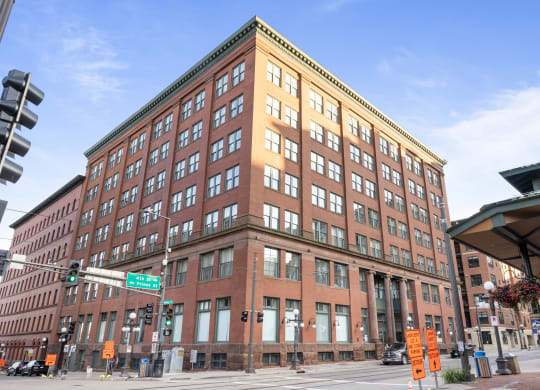 a large brick building on the corner of a city street