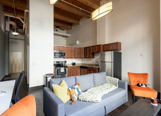 a living room with a couch and a kitchen in the background