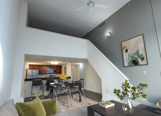 a living room with a dining room table and a kitchen