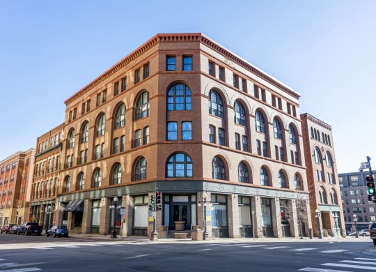 a large brick building on the corner of a city street