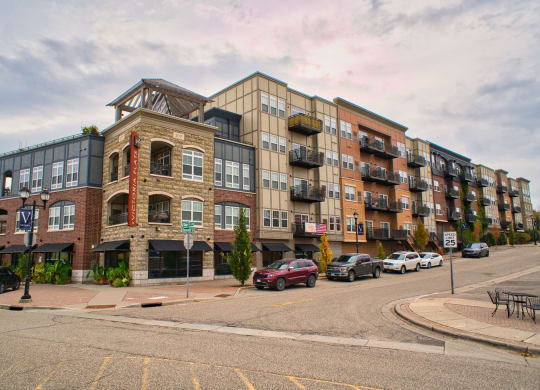 an apartment building on the corner of a street with cars in downtown Victoria, MN