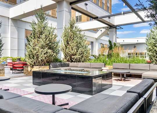 A modern outdoor seating area with a black and white checkered floor.