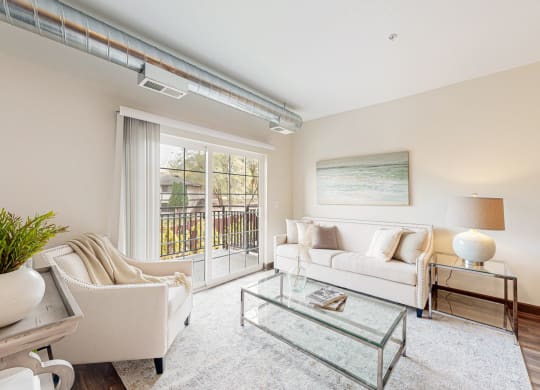 a living room with a couch and a glass coffee table