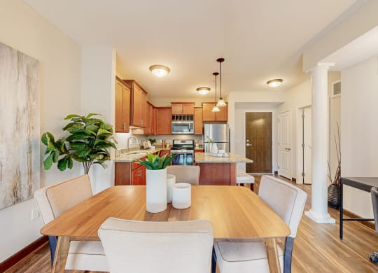 a dining room and kitchen with a table and chairs