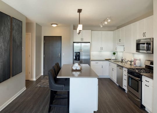 Kitchen With White Cabinetry And Black Appliances Residences at 1700, Minnetonka