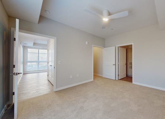 large empty primary bedroom with closet and private bath