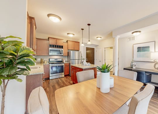 a dining room and kitchen with a table and chairs