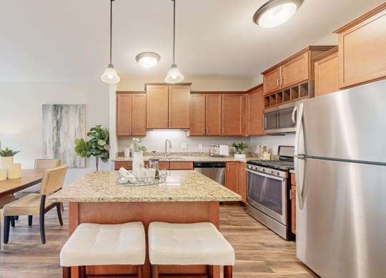 a kitchen and dining room with wood cabinets and stainless steel appliances
