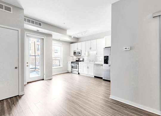 A kitchen with white appliances and cabinets.