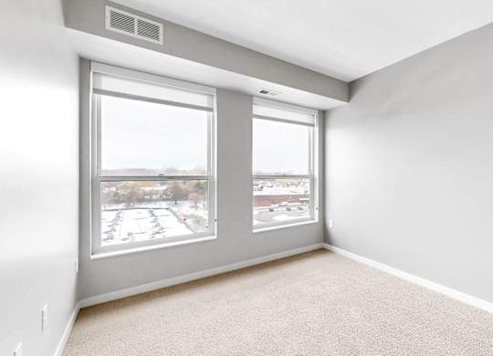 A room with a large window and a sliding glass door.