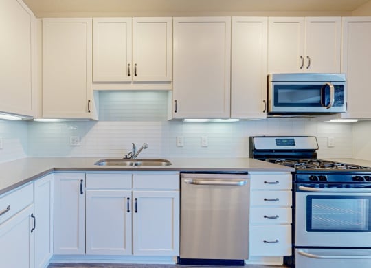 beautiful kitchen with white cabinetry and countertops