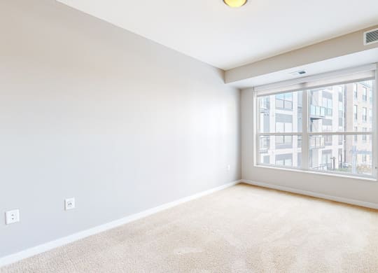 a spacious bedroom with white walls