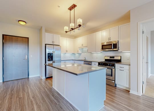 a large kitchen with white cabinets and a counter top