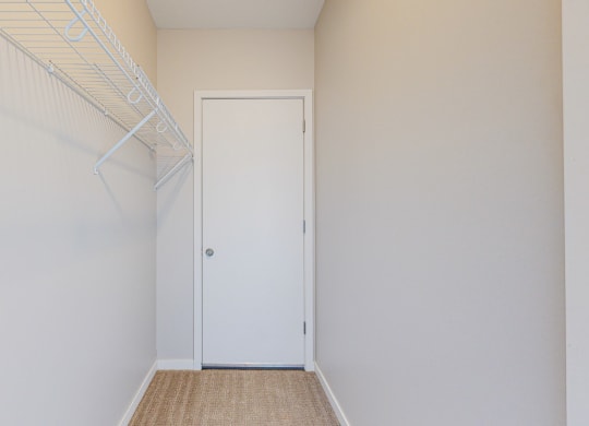 spacious walk in closet with built in wiring shelving