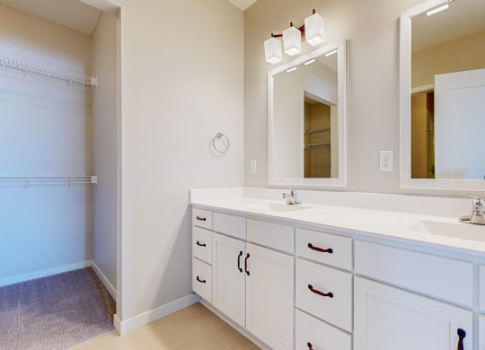 a bathroom with two sinks and a mirror